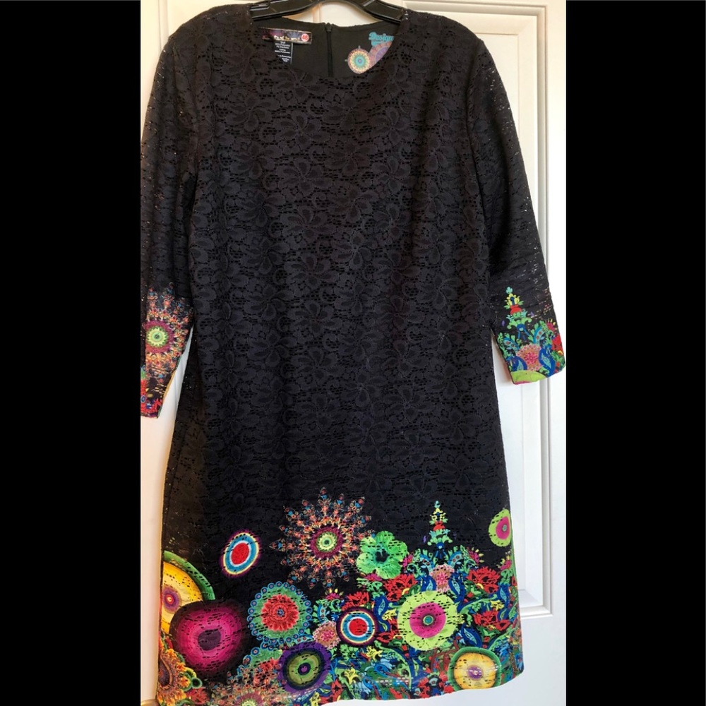 Navy lace-patterned dress edged in floral & fauna.